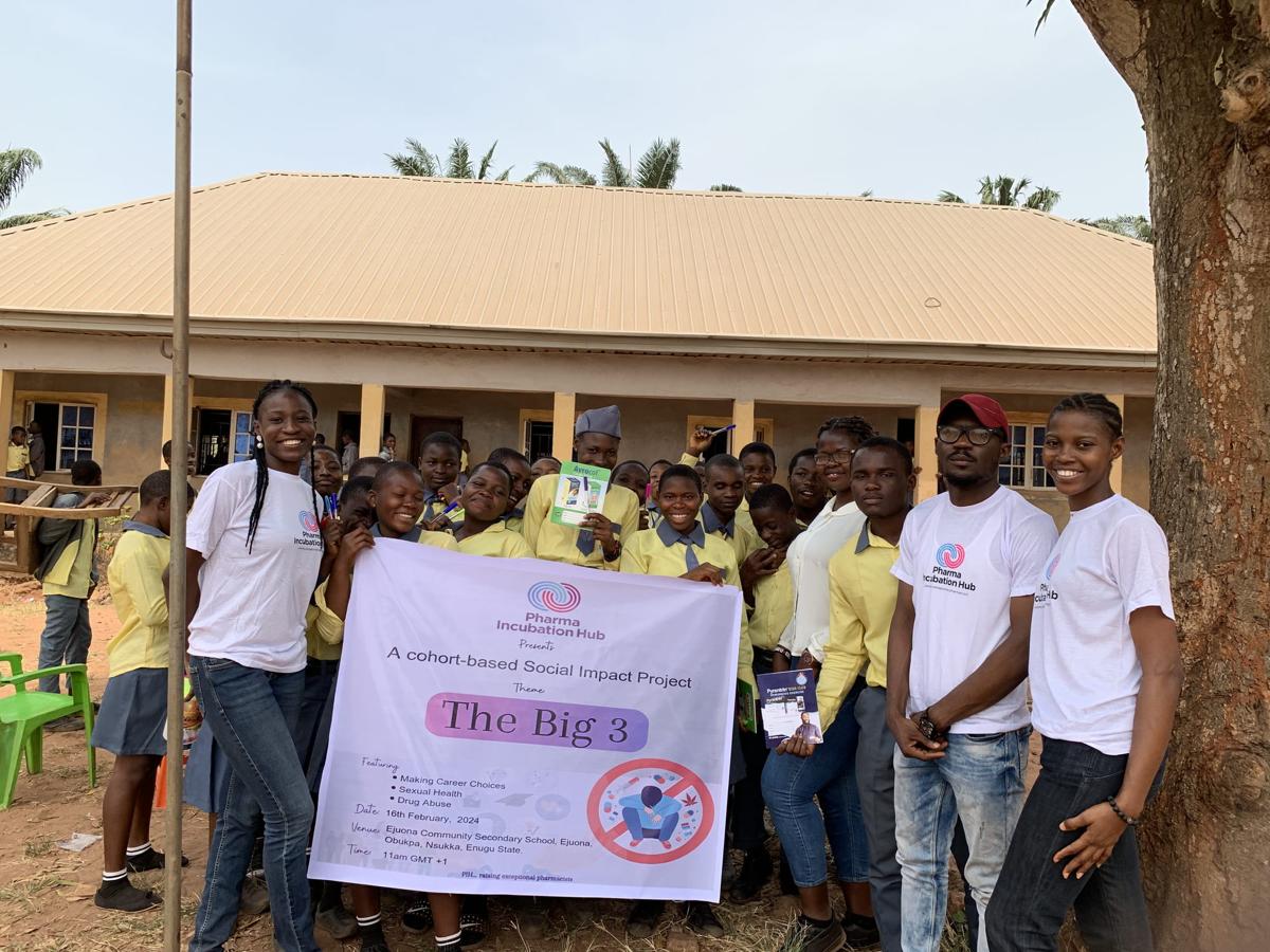 Fellows in Pharma Incubation Hub shirts hold The Big 3 project banner, surrounded by secondary school students in yellow uniforms